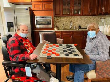 Seniors playing checkers at the bistro